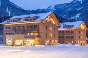 A multi-story hotel with balconies, a ski lift, and a snowy mountain backdrop. - Dormio Aparthotel Hinterstoder (Hinterstoder)