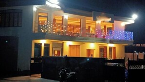 A two-story building with balconies, illuminated by exterior lights. - Lahaven Guest House (Shillong)