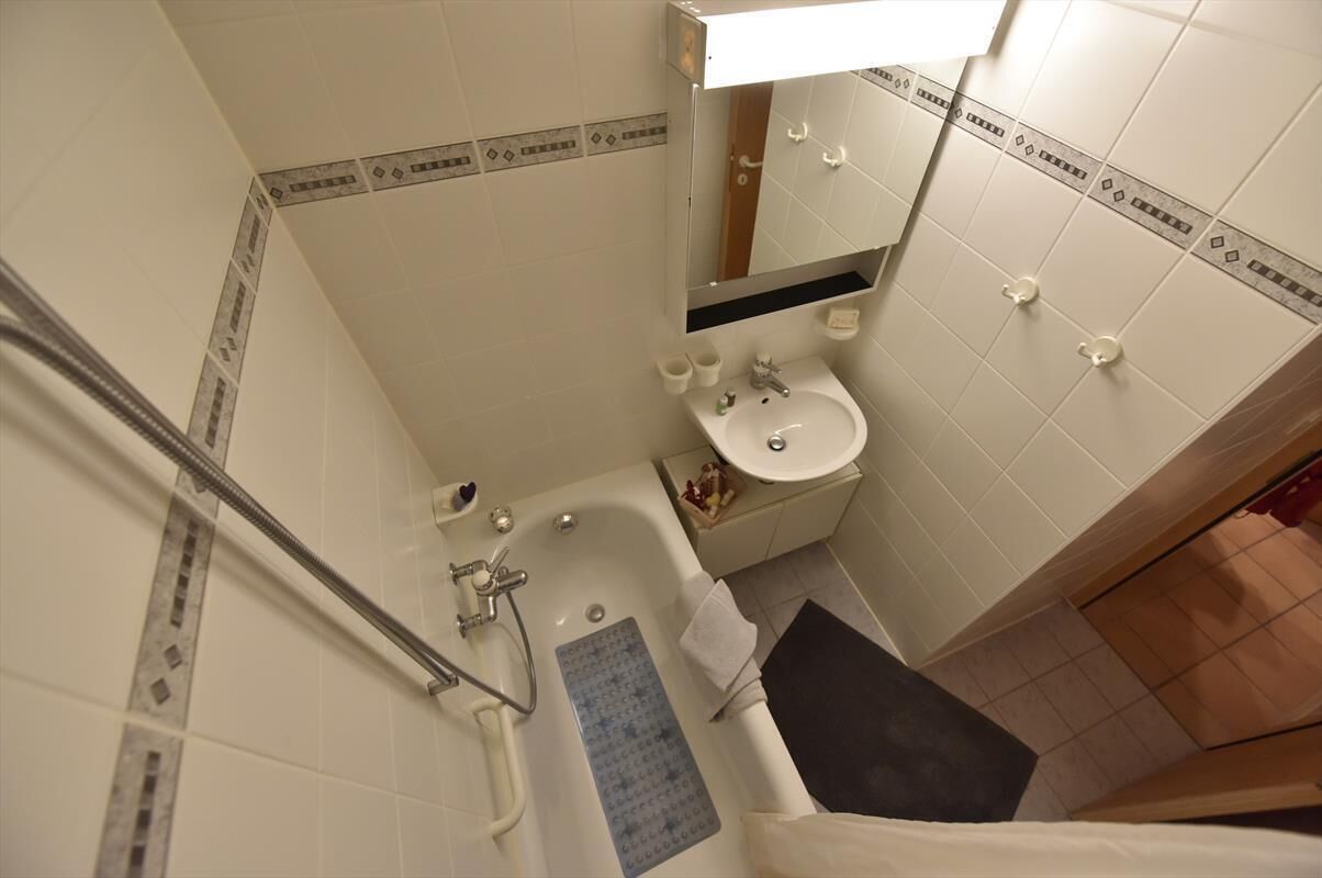 Un baño con bañera, lavabo y espejo.