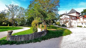 A historic building with a garden pathway leading to it.