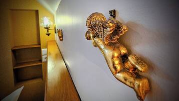 A staircase with a wall-mounted golden sculpture of a figure.