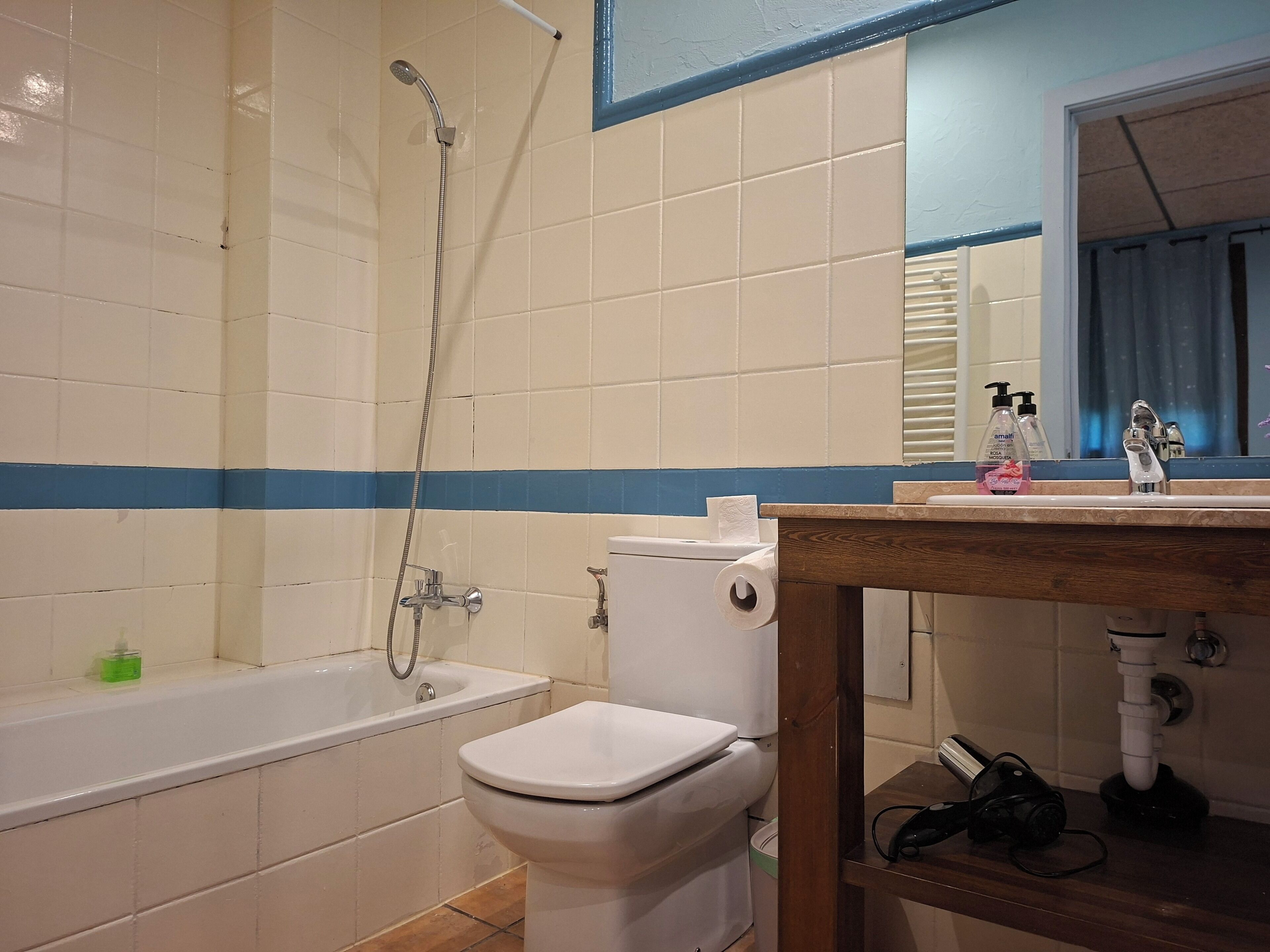 A bathroom with a bathtub, toilet, and sink.