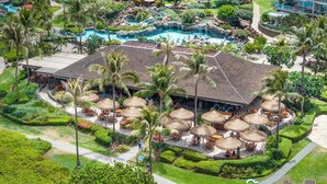 A resort with a pool area, outdoor seating, and lush landscaping. - 1BD Peaceful Oceanfront Maui Escape w/ AC, Lanai & Island-to-Island Views - Mahana 1118 (Lahaina)