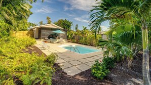 A backyard with a swimming pool, patio furniture, and lush greenery. - Walk to the Bay: Pet-friendly Oasis in Sarasota! (Sarasota)