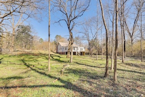 A house surrounded by trees and a grassy yard.