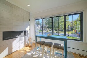 A modern kitchen with a large window, a built-in stove, and two bar stools. - Near Casinos & Lake Michigan: Hammond Home! (Hammond)