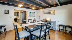 A dining area with a wooden table, chairs, and a kitchen in the background. - Pet Friendly! Near Casinos & Lake Michigan Beaches (Hammond)