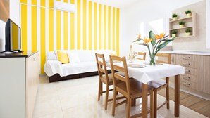 A modern kitchen with a dining area, a sofa, and a TV. - Vacation Home 'Holiday Esquinita' with Wi-Fi and Air Conditioning (San Bartolomé de Tirajana)