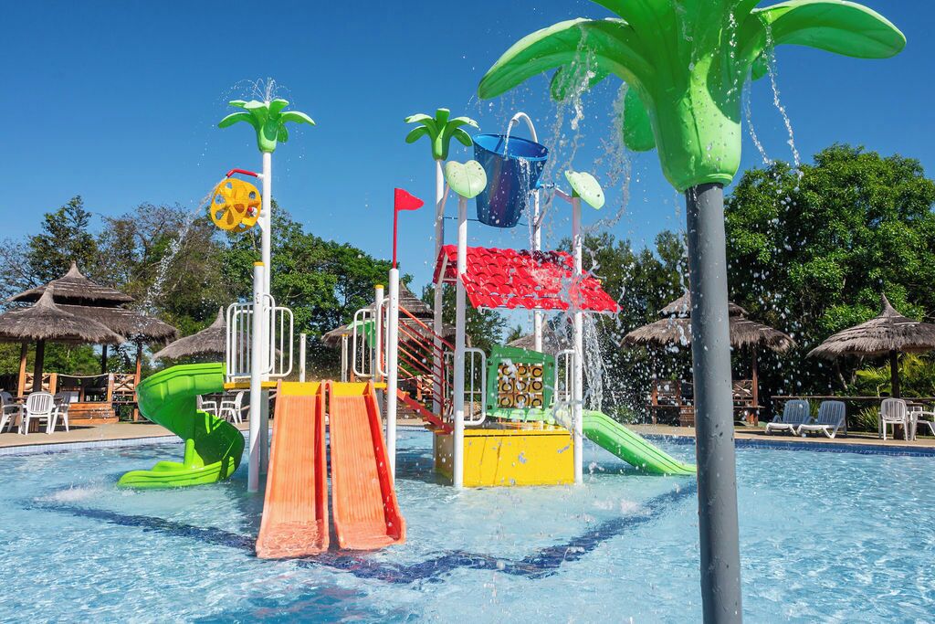A water park with slides, water jets, and a pool.