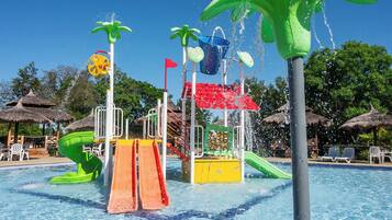 A water park with slides, water jets, and a pool.