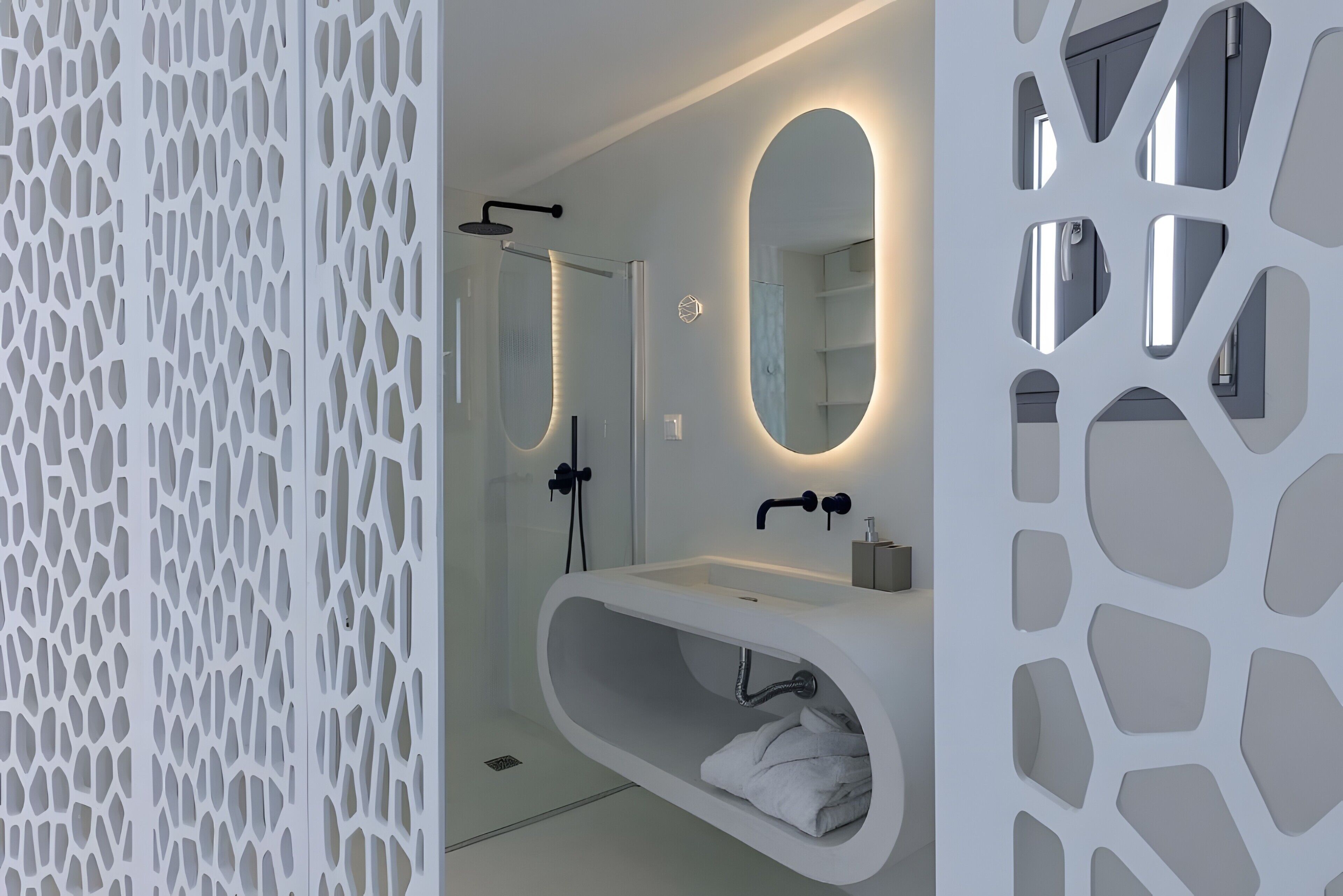 A modern bathroom with a freestanding bathtub, a large mirror, and a shower enclosure.