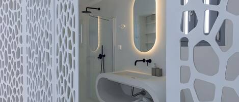 A modern bathroom with a freestanding bathtub, a large mirror, and a shower enclosure.