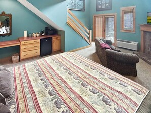 A bedroom with a bed, a desk, a chair, and a staircase. - King suite in Nantahala Village w/ fireplace, WiFi, and mtn views. Free train, rafting, and zip tix (Bryson City)