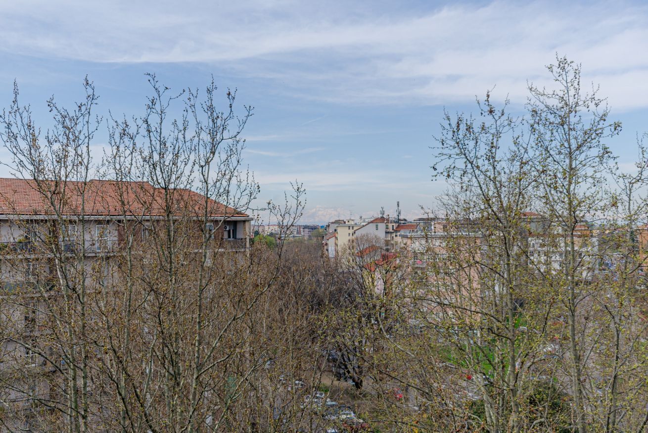 A view of a residential area with buildings and bare trees.