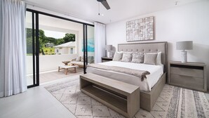 A modern bedroom with a large bed, a bedside table, a bench, and a view of the outdoors. - Sorrento 15 2 Bedroom Townhouse (Gibbes)