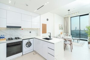 Departamento exclusivo, vista a la ciudad | Cocina privada | Refrigerador con congelador, microondas, horno y parrilla de estufa 
