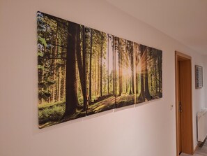 A large wall-mounted artwork depicting a forest scene. - Double Room on the Forest Edge with a View (Schmallenberg)