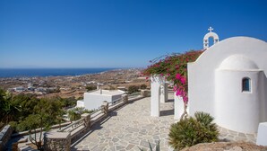A white building with a bell tower, stone steps, and a view of the landscape. - Scorpios Dream By Bestofmikonos Country House with Private Pool, Wi-Fi & Air Conditioning (Mykonos)