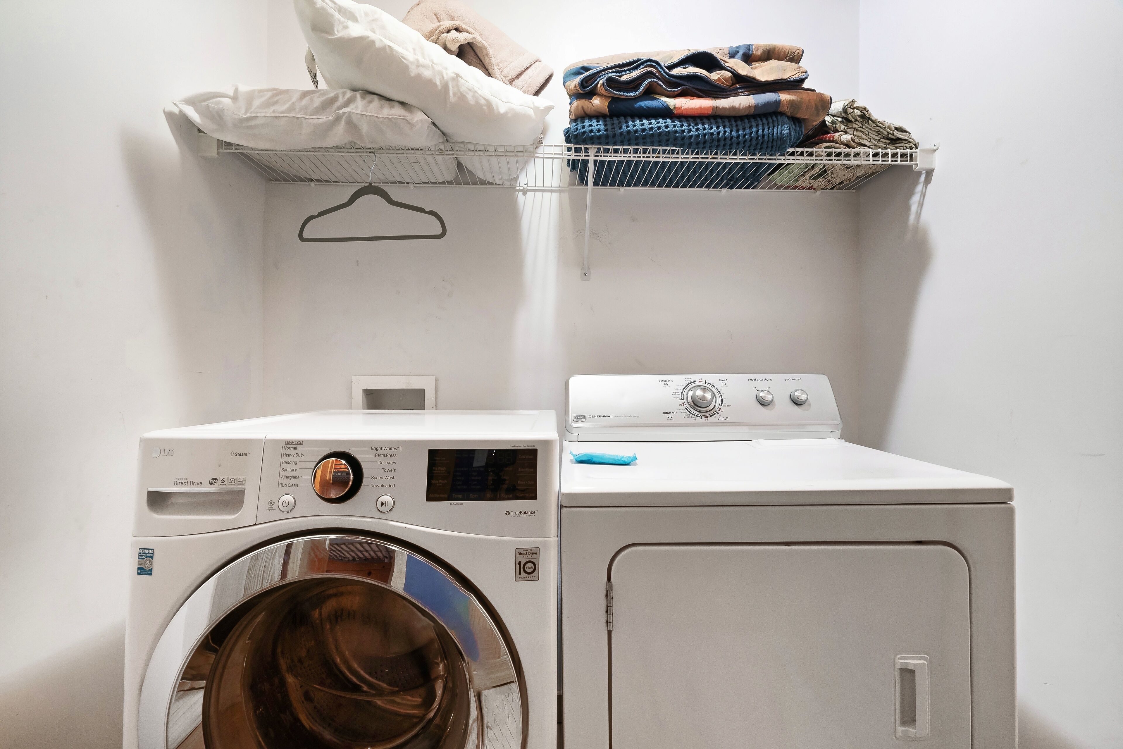 Un espace buanderie équipé d’un lave-linge à chargement frontal et d’un appareil combiné lave-linge et sèche-linge.