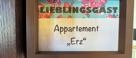 A framed sign with the text 'LIEBLINGSGAST' and 'Appartement Erz'.