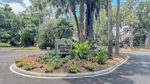 A sign for Inverness Village with a landscaped flower bed in front. - Large Three Bedroom Villa with Several Updates and Large Deck on Golf Course! (Hilton Head)