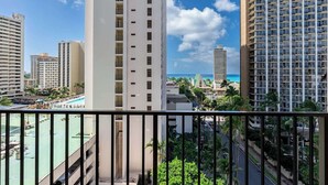 A high-rise hotel with multiple balconies, a pool area, and a view of the ocean. - Chic Suite W/ Direct Ocean Views & Free Parking (Honolulu)