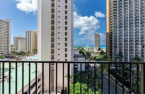 A high-rise hotel with multiple balconies, a pool area, and a view of the ocean. - Chic Suite W/ Direct Ocean Views & Free Parking (Honolulu)