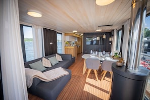 Un intérieur moderne comprenant un canapé, une table à manger et un coin cuisine.