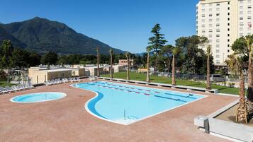 Seasonal outdoor pool, pool umbrellas, pool loungers