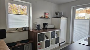 A modern kitchen with a built-in coffee maker, a toaster, and a refrigerator. - Apartment "Olsberg View Whg. B" with Mountain View, Shared Garden and Wi-Fi (Olsberg)