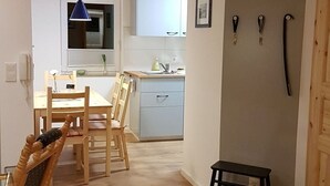 A compact kitchen with a sink, cabinets, and a blue pendant light. - Apartment "Olsberg Blick Whg.A" with Mountain View, Garden & Wi-Fi (Olsberg)