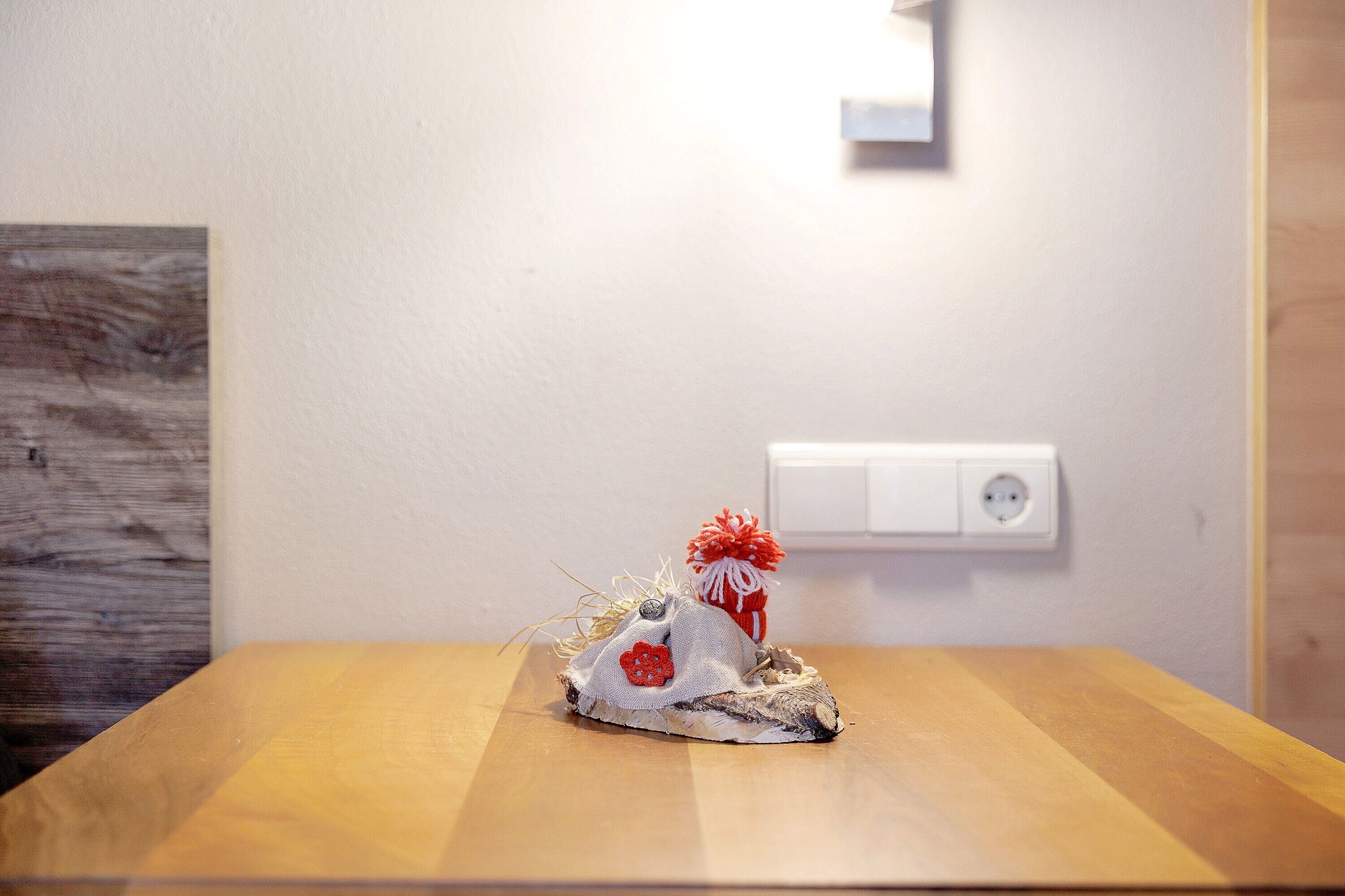 A wooden table with a decorative item on it.