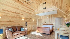 A wooden interior with a sofa, a bed, and a dining table. - 1 bedroom accommodation in Ripponden (Ripponden)