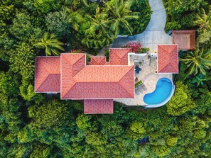 An aerial view of a resort with multiple buildings, a swimming pool, and lush greenery. - AnaCapri Estate-Beautiful Caribbean Villa with pool and sea views (Tortola)