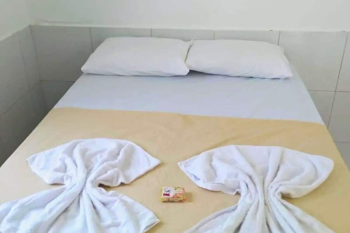 A hotel room with a bed and a table.