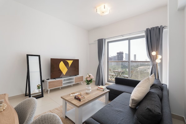 Luxury Apartment, Balcony, City View | Living area | 65-inch Smart TV with cable channels