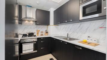 Luxury Apartment, Balcony, City View | Private kitchen | Full-sized fridge, microwave, oven, stovetop