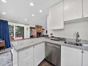 A modern kitchen with white cabinets, granite countertops, and stainless steel appliances. - Aspen Hideaway – Modern 2BR/2BA Condo Steps from Giant Steps Lifts (Brian Head)