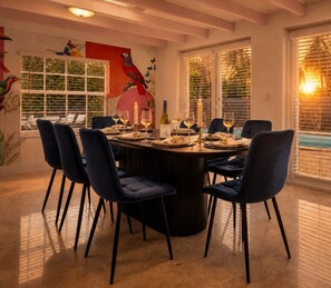 A dining area with a round table, six chairs, and candles. - Designer 4BR Villa • Pool • 30 min to WC Stadium (Fort Lauderdale)