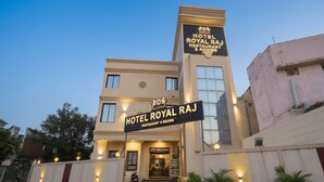A hotel named "Hotel Royal Raj" with a sign indicating it offers a restaurant and rooms. - Hotel Royal Raj (Rajkot)