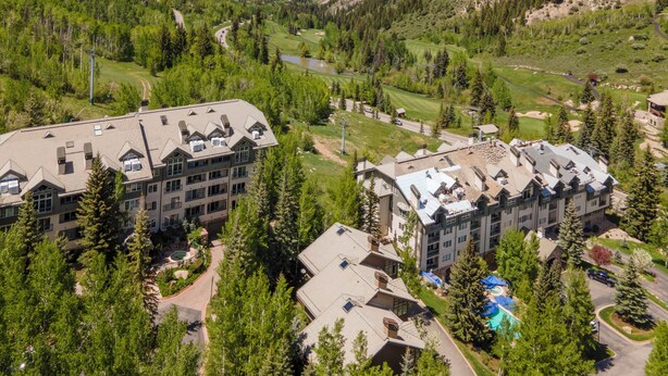 Un resort con diversi edifici, una piscina e un campo da golf.