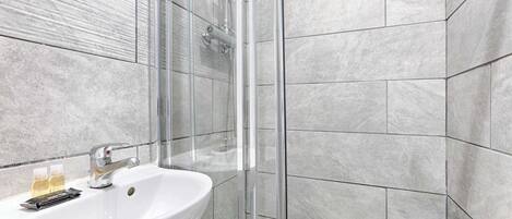 Shower, hair dryer, towels, toilet paper