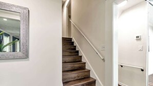 A staircase with wooden steps and white walls. - ALL Kings!/ Gameroom/ Huge Deck/ Family Friendly (Norcross)