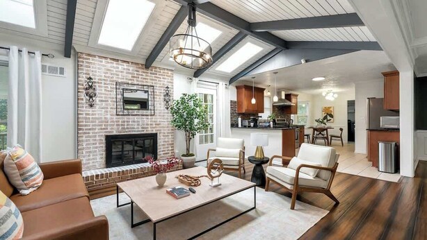 A spacious living room with a fireplace, a dining area, and a kitchen. - ALL Kings!/ Gameroom/ Huge Deck/ Family Friendly (Norcross)