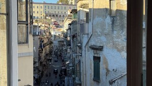 A narrow street with buildings on both sides, balconies, and a clear sky. - The Royal Penthouse 3-bedrooms with Panoramic Terrace (Napoli)