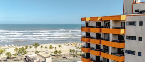 A beachfront hotel with multiple balconies overlooking the ocean.
