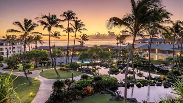 A resort with a pool, palm trees, and a view of the ocean at sunset. - Hilton Vacation Club Point At Poipu each unit has 2BR & kit.  in gorgeous Koloa (Koloa)