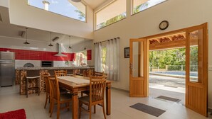 A spacious kitchen with a dining area, a large window, and a view of the outdoors.