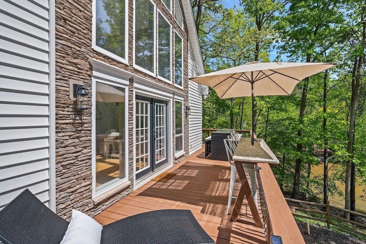 Une terrasse dotée de mobilier d  ’extérieur, d’une table et d’un parasol.