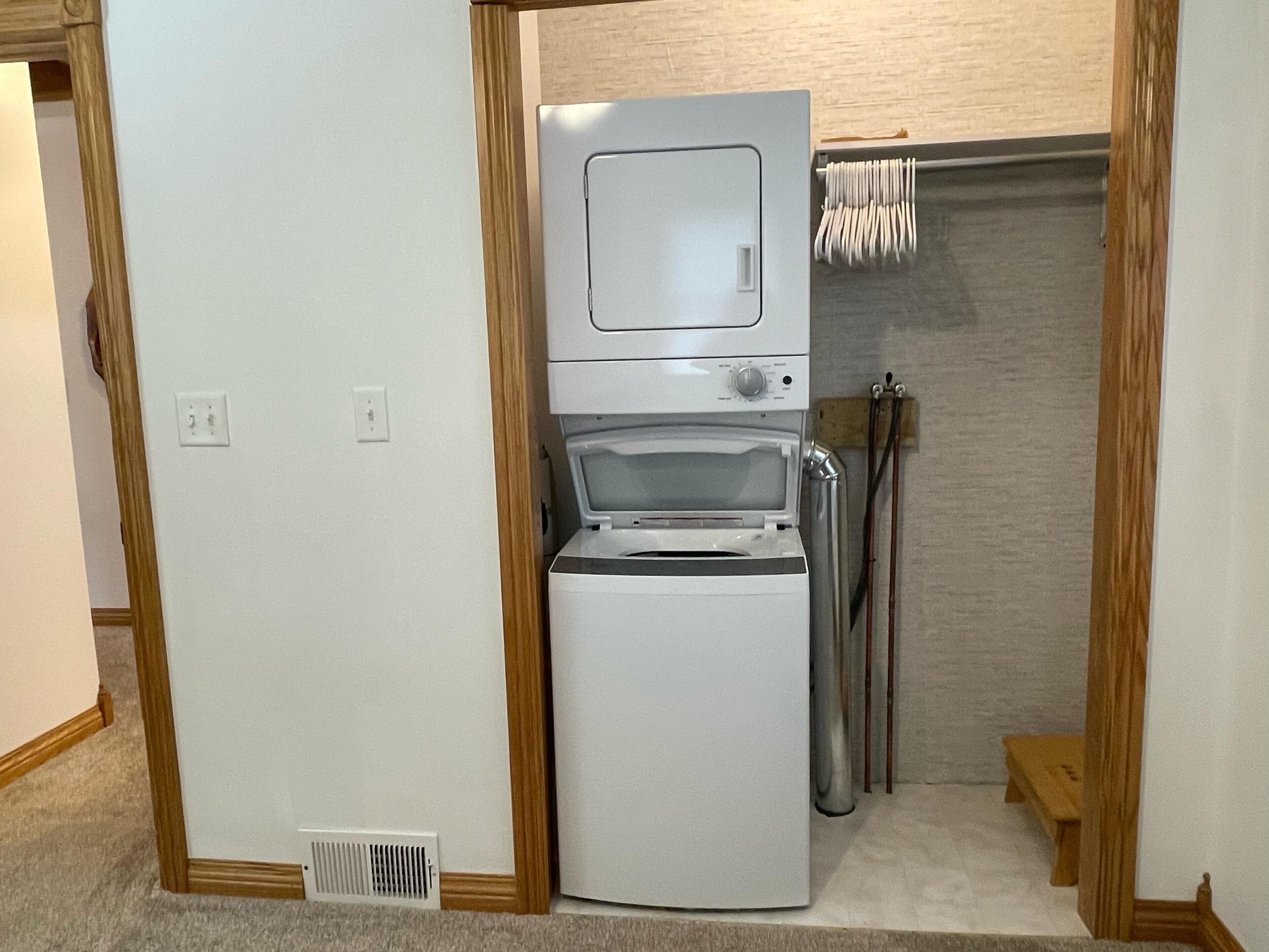 A compact kitchenette with a built-in microwave, oven, and sink.